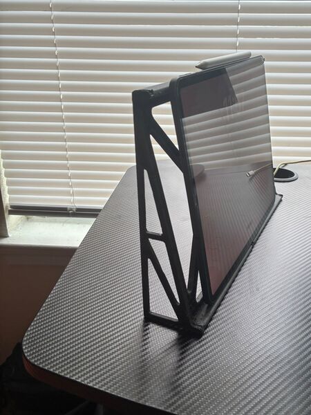 Upright stand with its triangular side truss holding an iPad Pro and Apple Pencil.