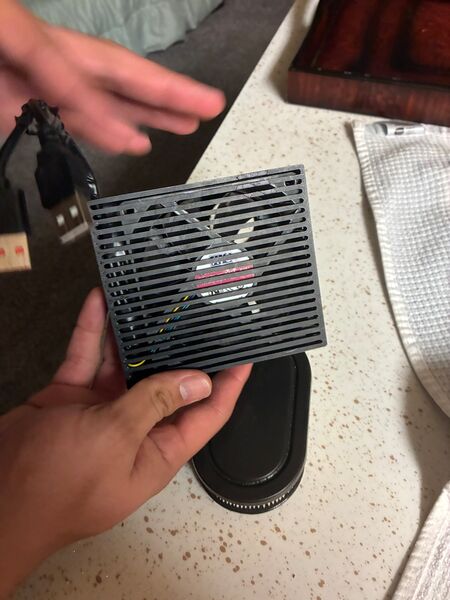 The printed louvered exhaust grille, with the fan behind it and the oval filter below.