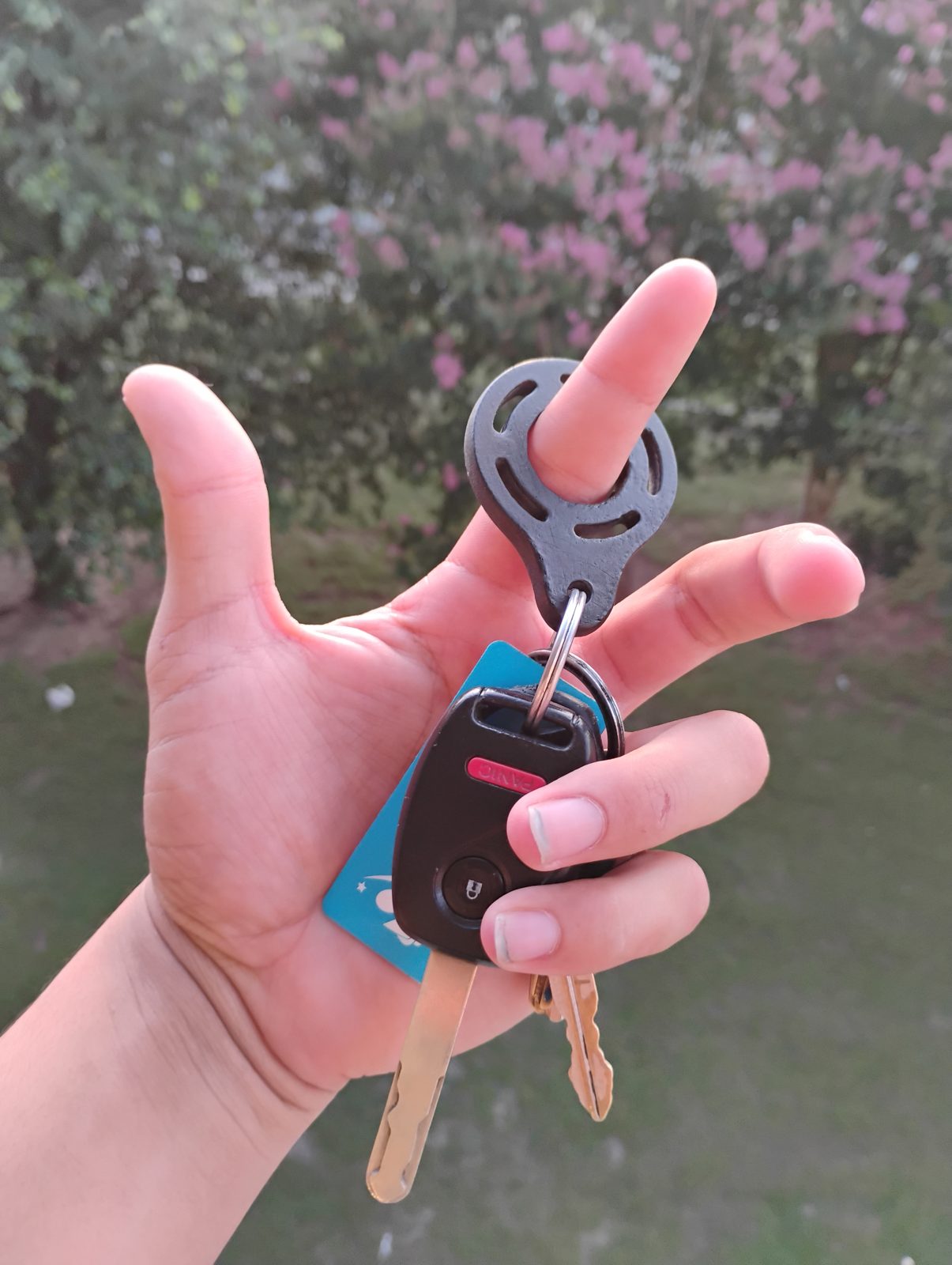 3D-printed carbon fiber key spinner spinning on a finger