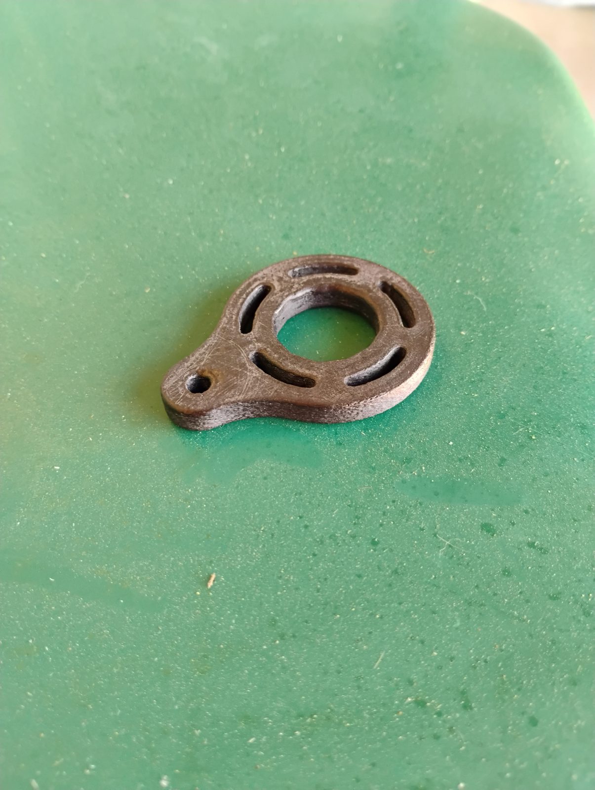 Carbon fiber keychain spinner showing the 3D-printed PA-612 texture and micro-ridged finger bore