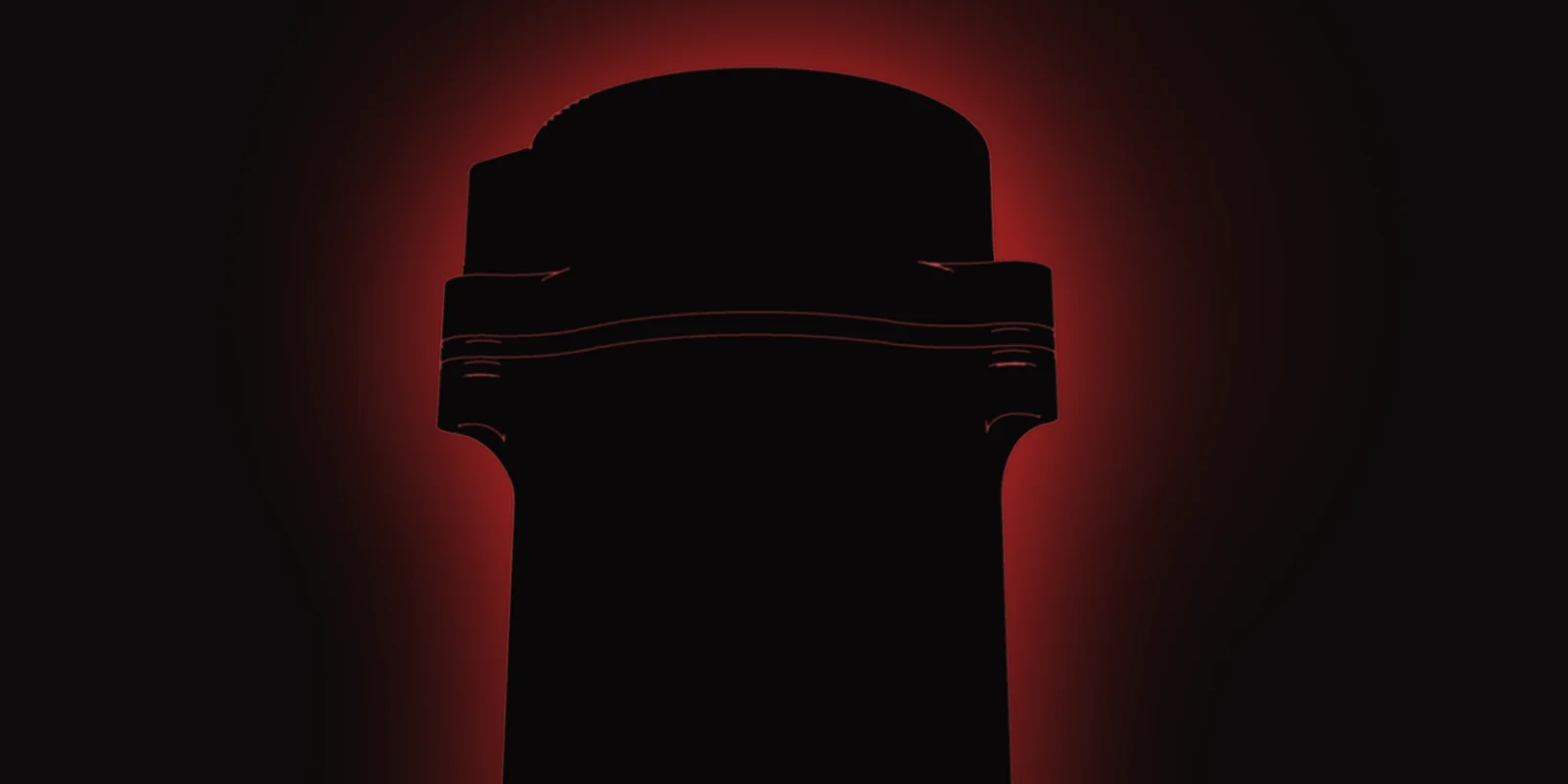 Backlit silhouette of the PRESION Rev 6 catch can against a red glow